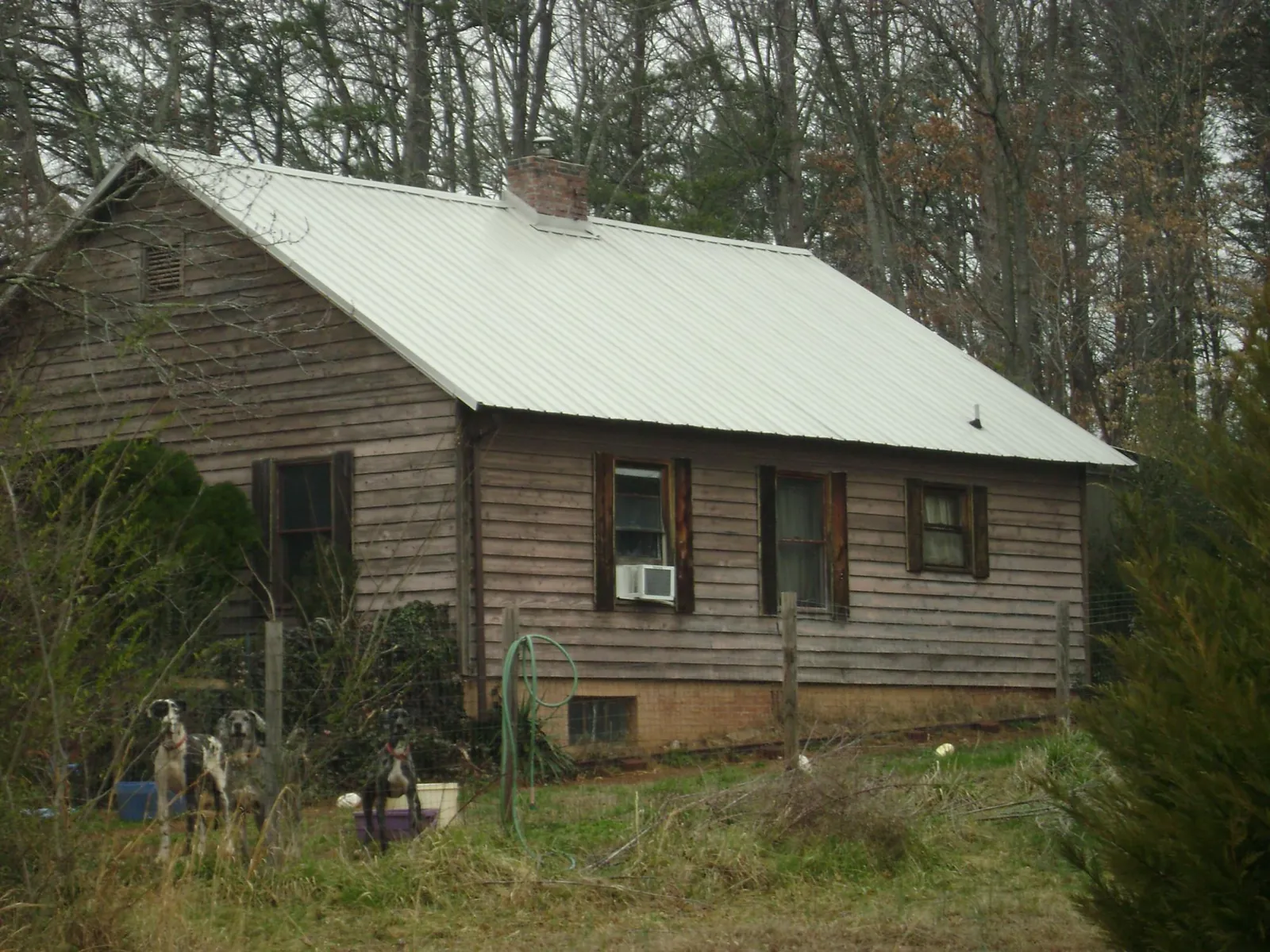White metal roof on an old wood sided farmhouse, from a Metal Roof Installation job in Tunnelton
